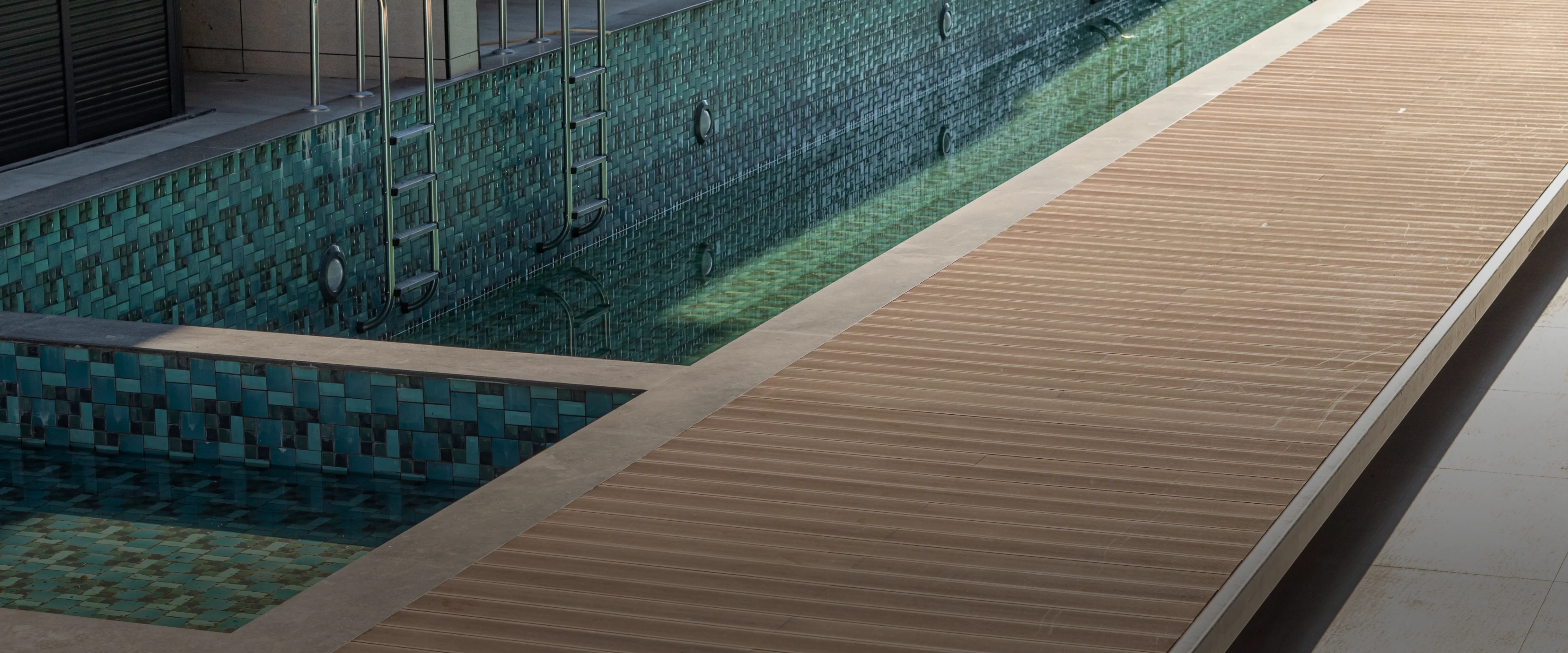 Premium Resysta composite pool deck overlooking the ocean at sunset