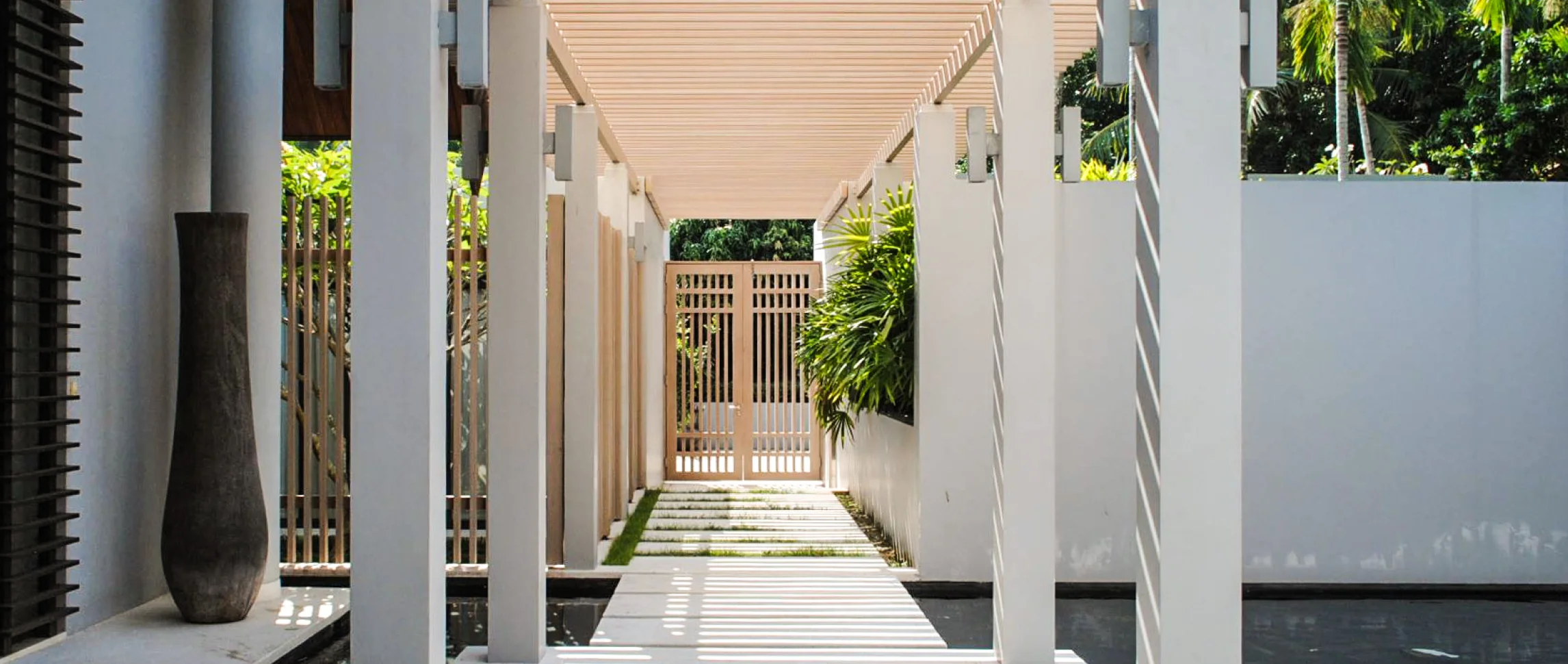 Outdoor walkway featuring Resysta privacy screens and fencing