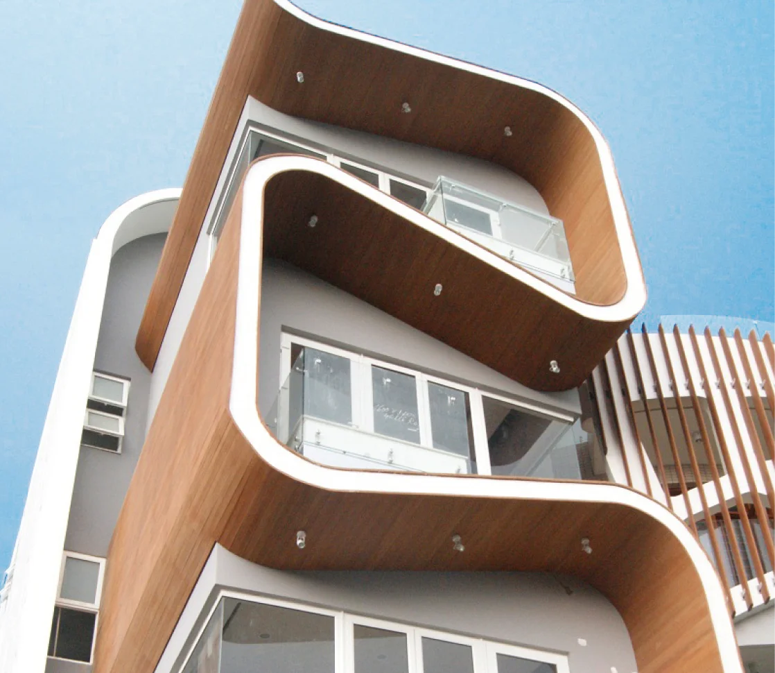 Modern building with Resysta horizontal siding next to a palm tree